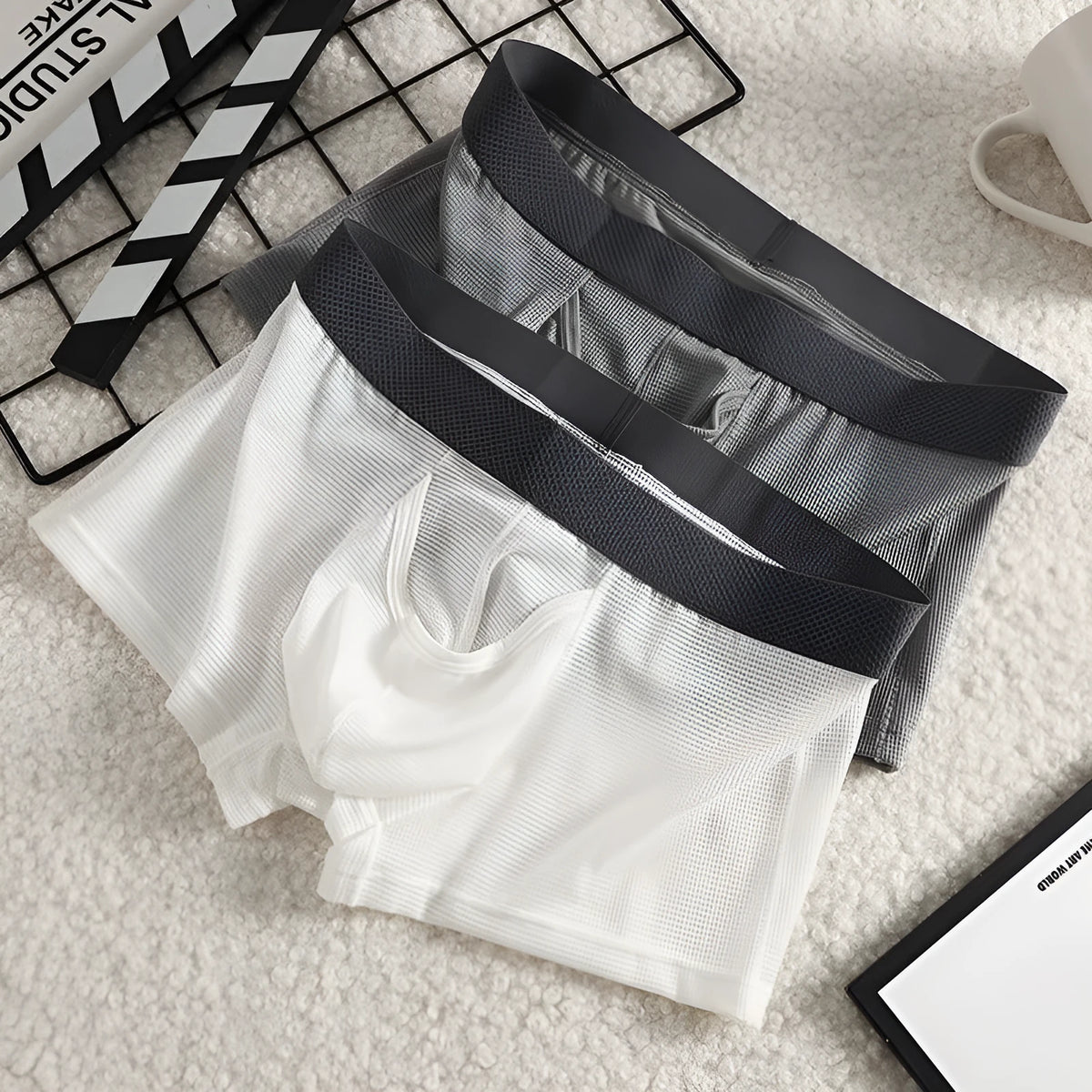 Solid colour men's ice silk boxer shorts with a low waist and knitted mesh fabric.