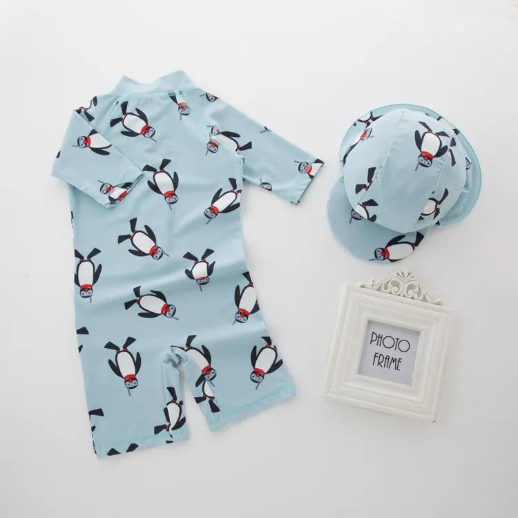 Boy's penguin print long sleeve one-piece swimsuit with matching swimming cap.