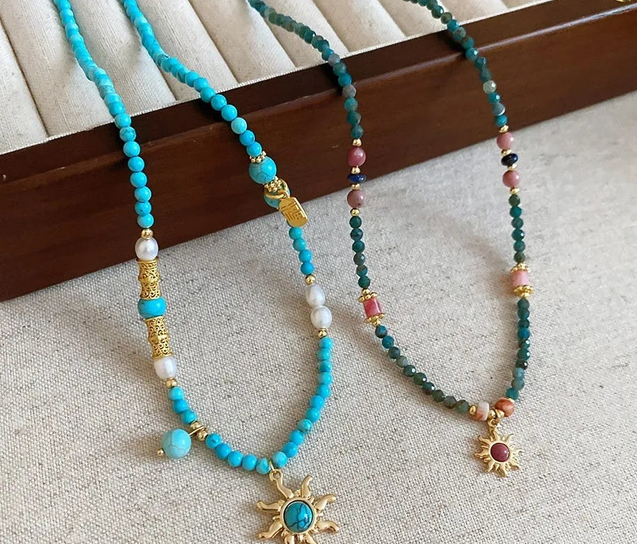 Freshwater pearl necklace with stone sun pendant in blue-sun colour option, court style geometric design