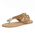 Women's black slip-on sandals with rhinestone decoration and flip-toe design on a white background.