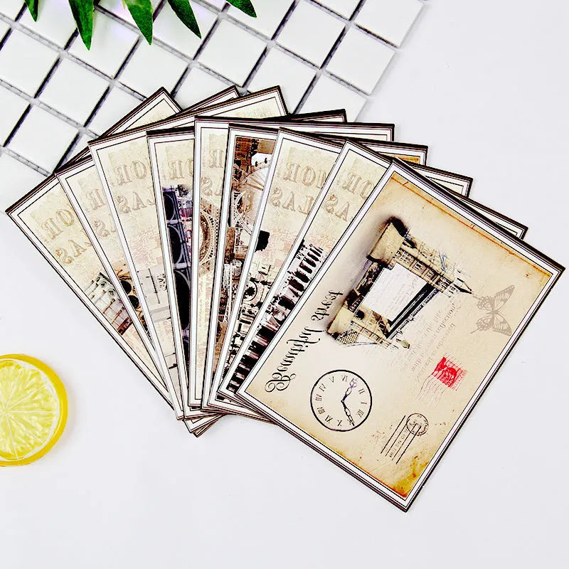 Set of nine retro-style postcards with cartoon illustrations of Paris towers and landmarks.