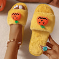 Halloween cartoon pumpkin design open-toe plush slippers on a white or yellow synthetic fur upper with PVC sole.