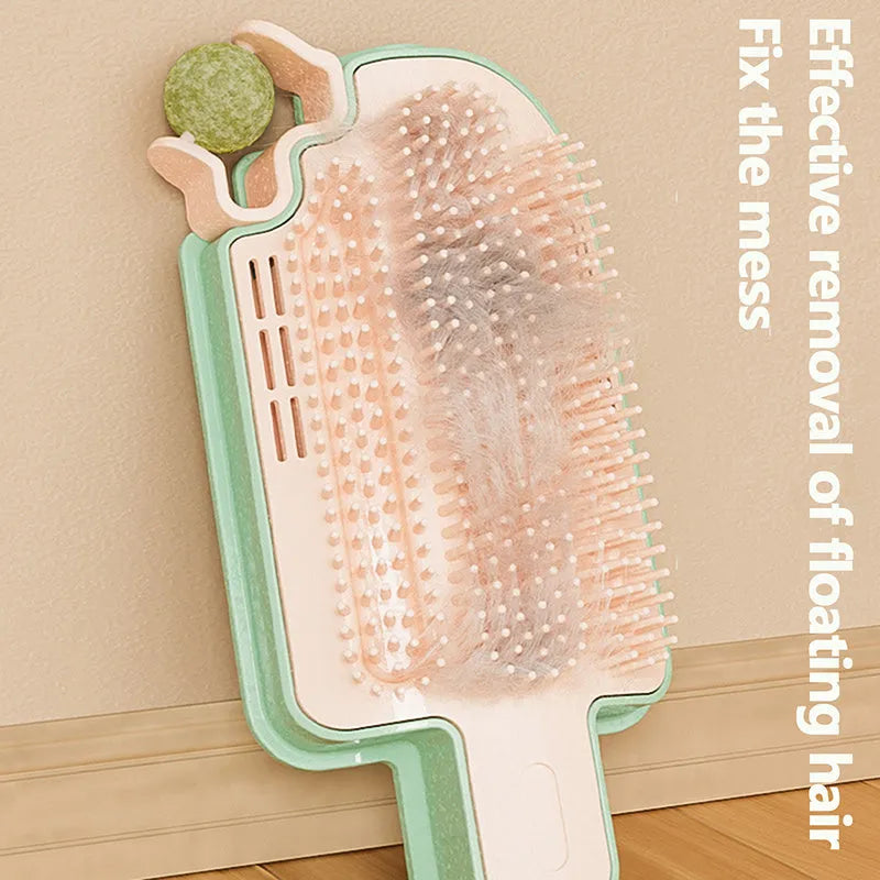Ice cream cone shaped cat grooming toy with mint ball and feather attachments on textured surface