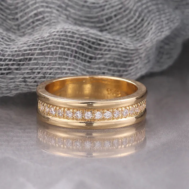 Gold plated copper geometric ring with inlaid zircon stone on white background