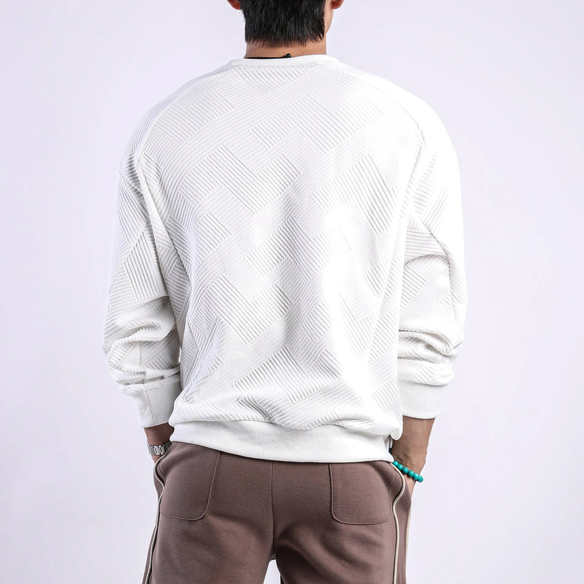 Men's loose fit twill Jacquard pullover sweater in army green, shown on a model.