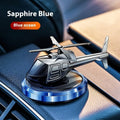 Silver metal solar-powered helicopter car air freshener ornament on a dashboard