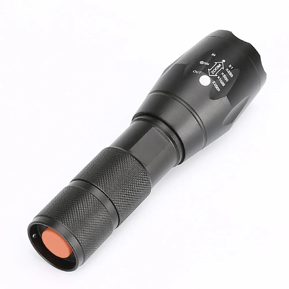 Black aluminium alloy zoomable LED flashlight with adjustable focus ring and textured grip.