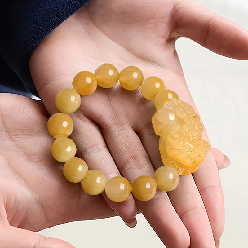 Personalised money symbol bracelet carved from golden thread jade, showing large and small size options.