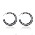 A pair of vintage-style C-shaped alloy earrings with an engraved surface, shown in bronze and silver colour options.