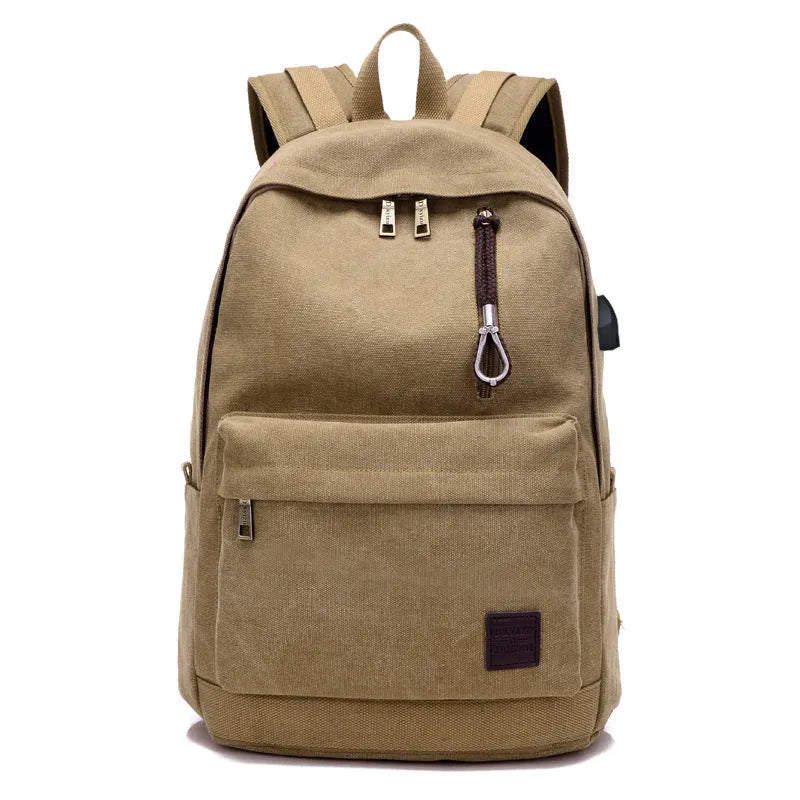 Canvas backpack with USB charging port shown in grey, featuring a laptop sleeve and front zipper pocket.