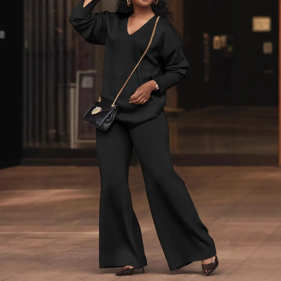 Women's brown suede velvet two-piece casual suit with long sleeves and trousers on a hanger.