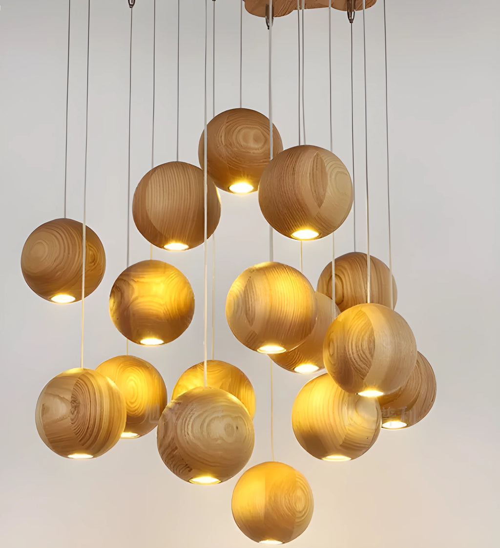 Nordic wood ball chandelier pendant light with adjustable cord, shown in a dining room setting.