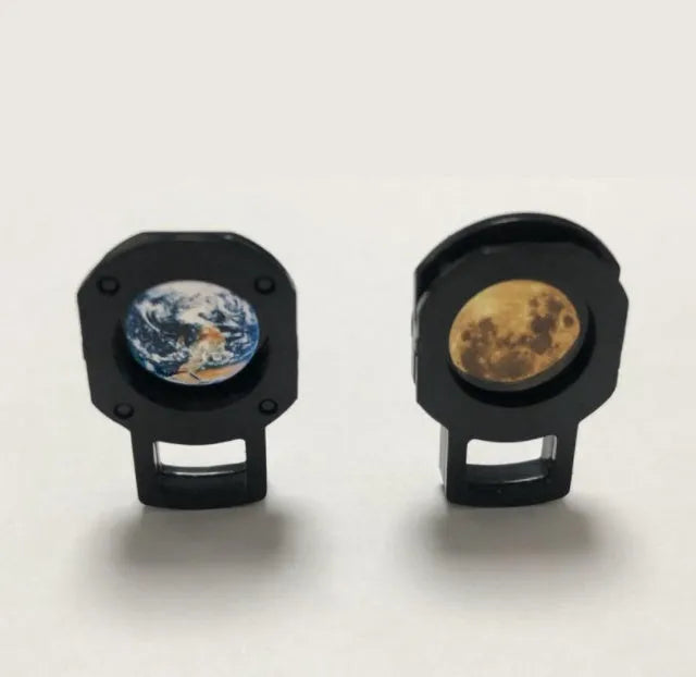 Earth and Moon projector lamp with flexible hose bracket on a table, showing USB cable