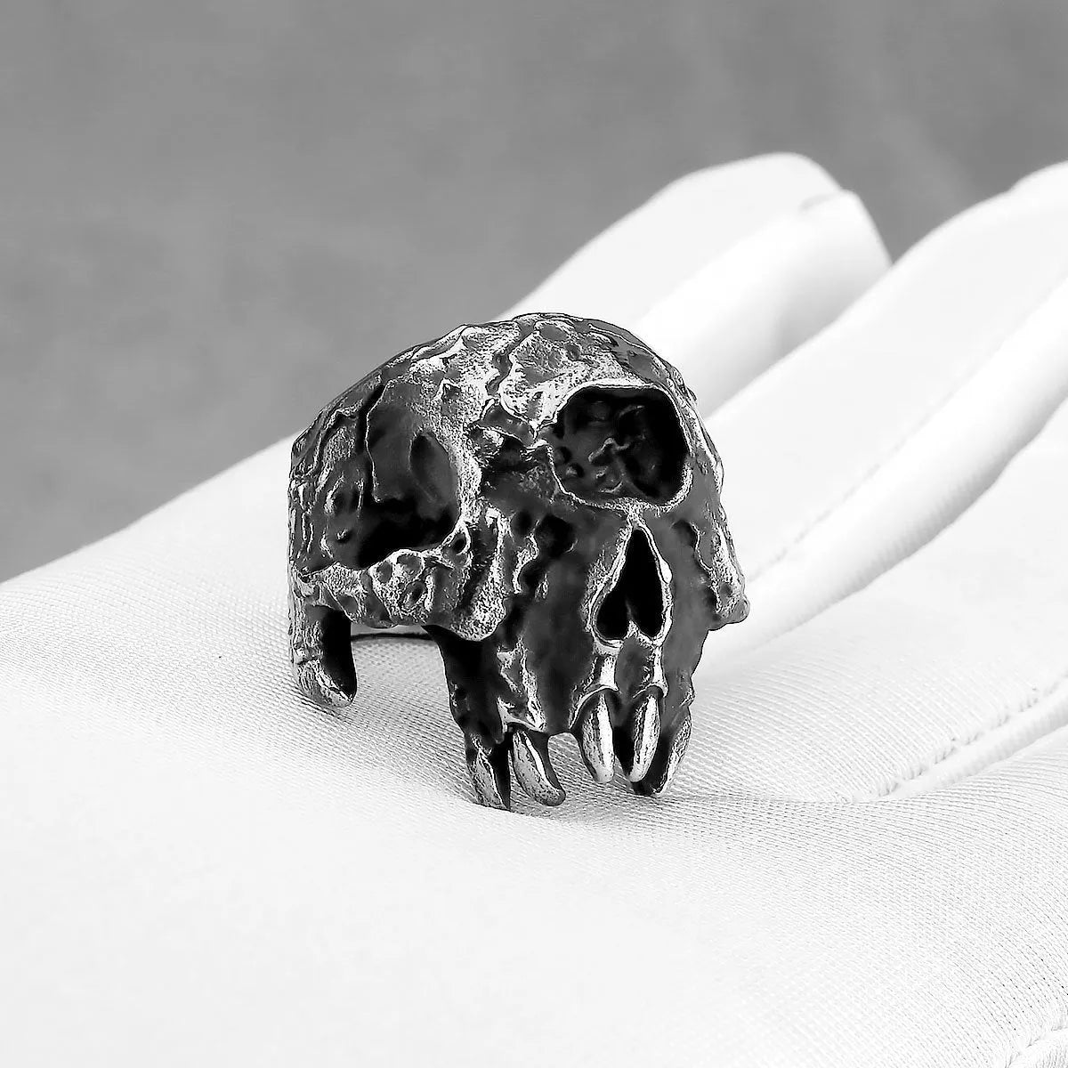 Alloy skull ring with one-eyed design in silver electroplated finish shown on finger