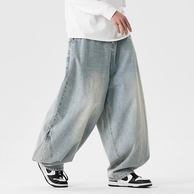 Men's plus size wide leg baggy jeans in black denim on a hanger