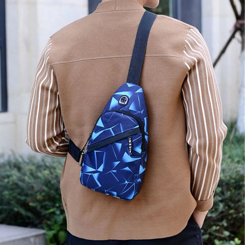 Men's medium blue Oxford cloth crossbody bag showing earphone hole and zipper opening.