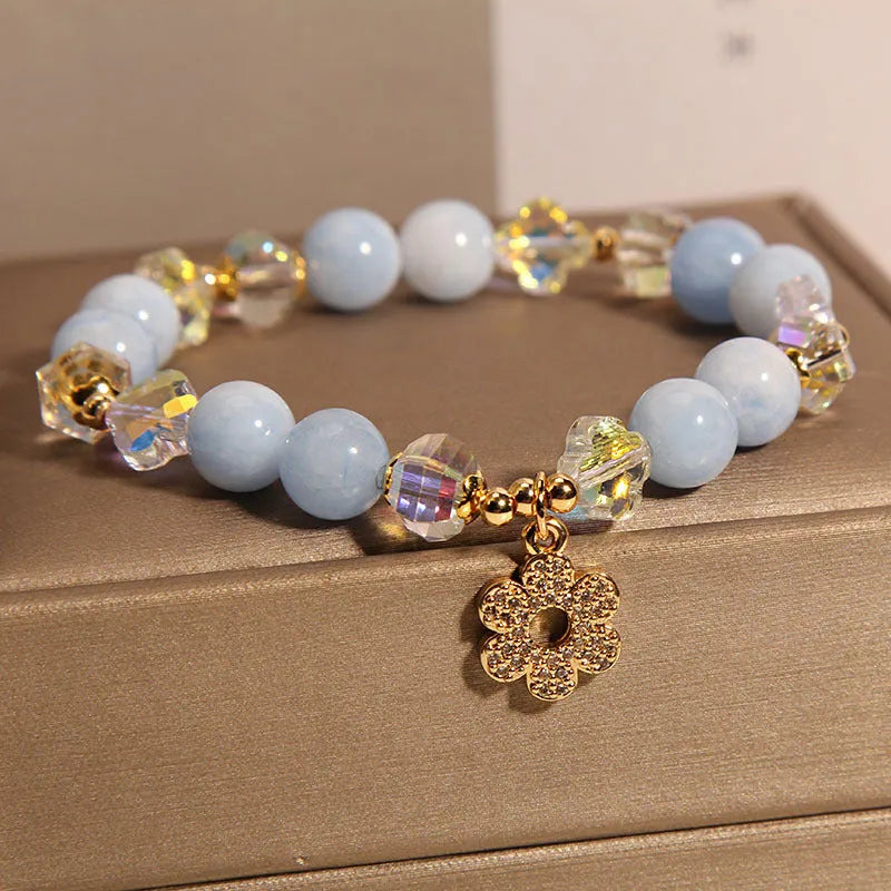 Women's aquamarine crystal four-leaf clover bracelet with pearl detail on adjustable silver chain