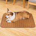 Brown woven rattan fibre cooling mat for dogs on a wooden floor.