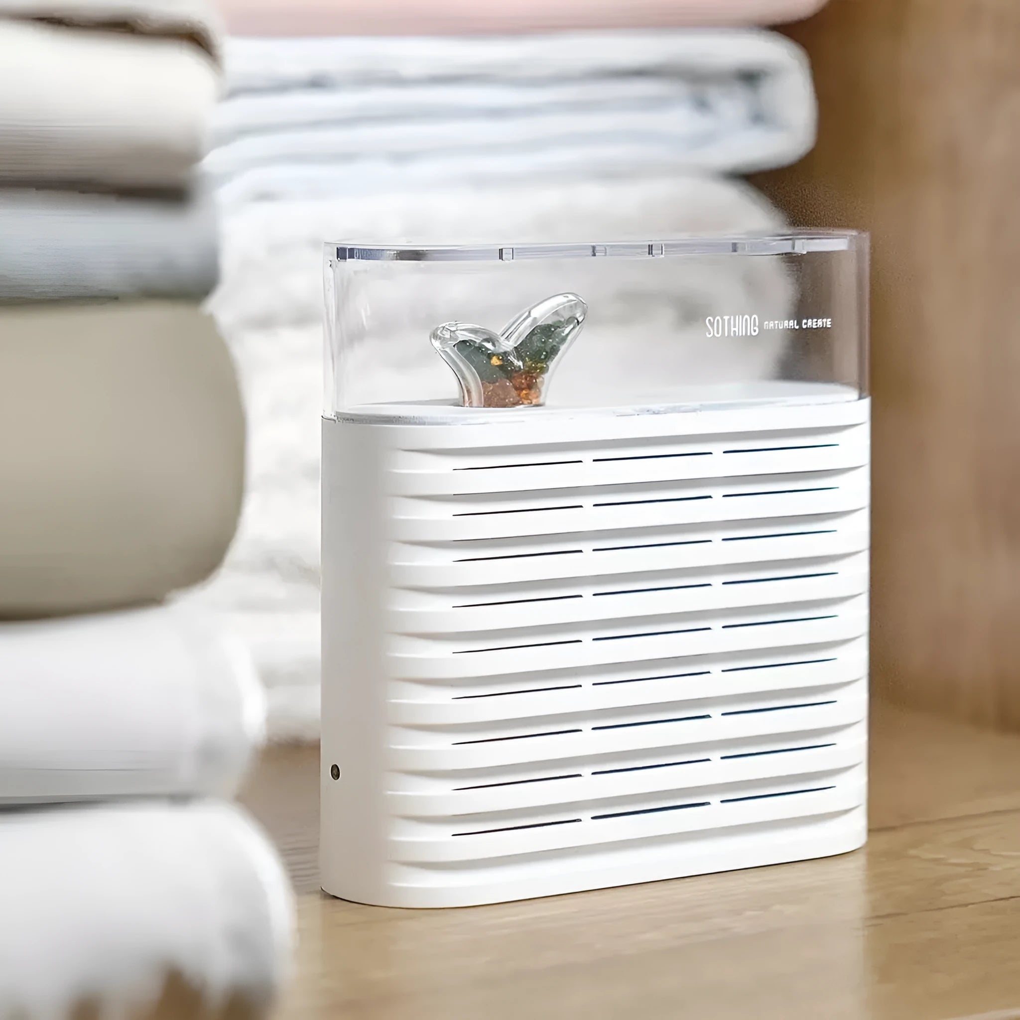 White recyclable cabinet dehumidifier box with clear top showing orange silica gel beads.