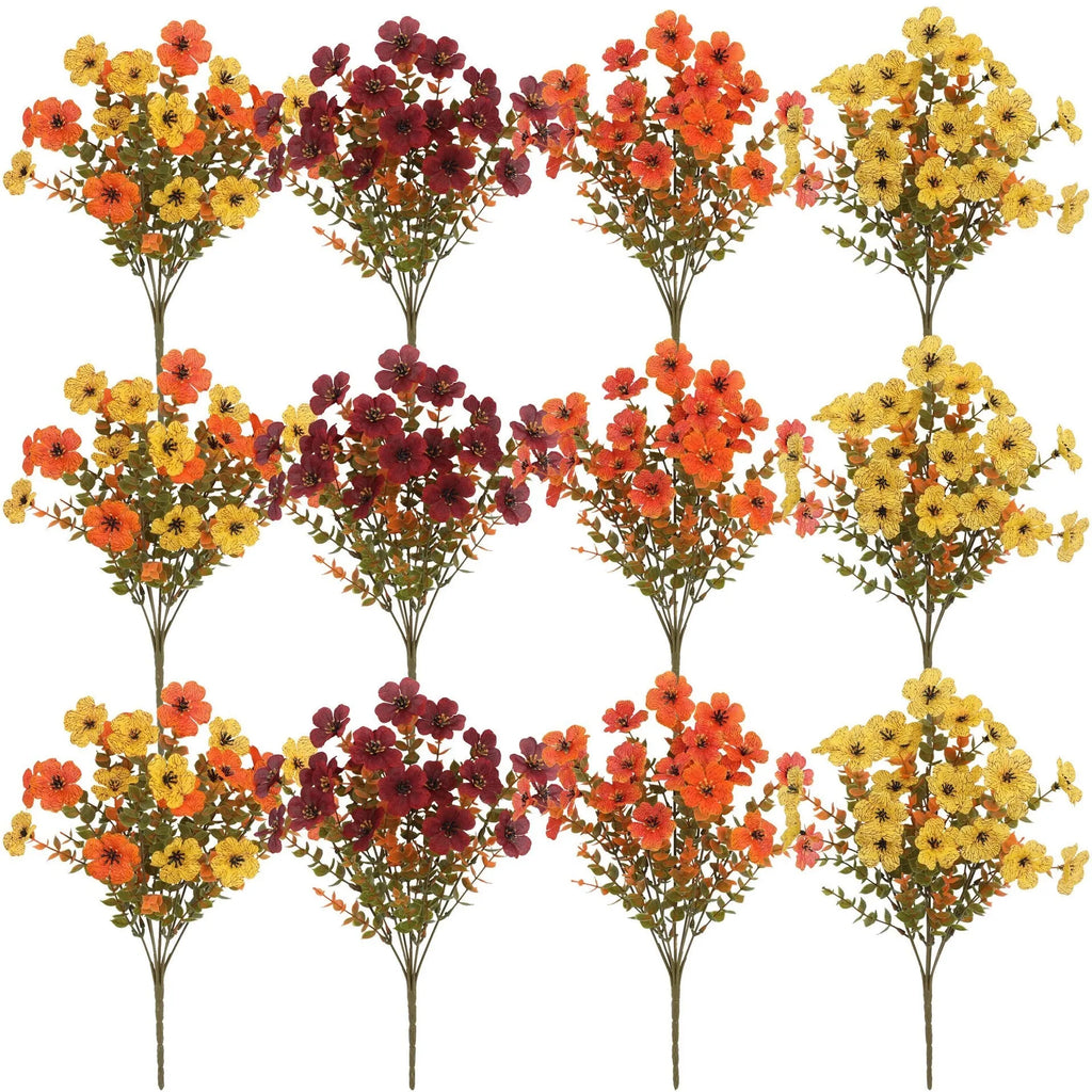 Artificial silk and plastic flower bouquet in autumn colours of red, yellow, and orange for home or wedding decoration