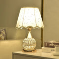 Gold crystal desk lamp with iron art base and remote control on a wooden table