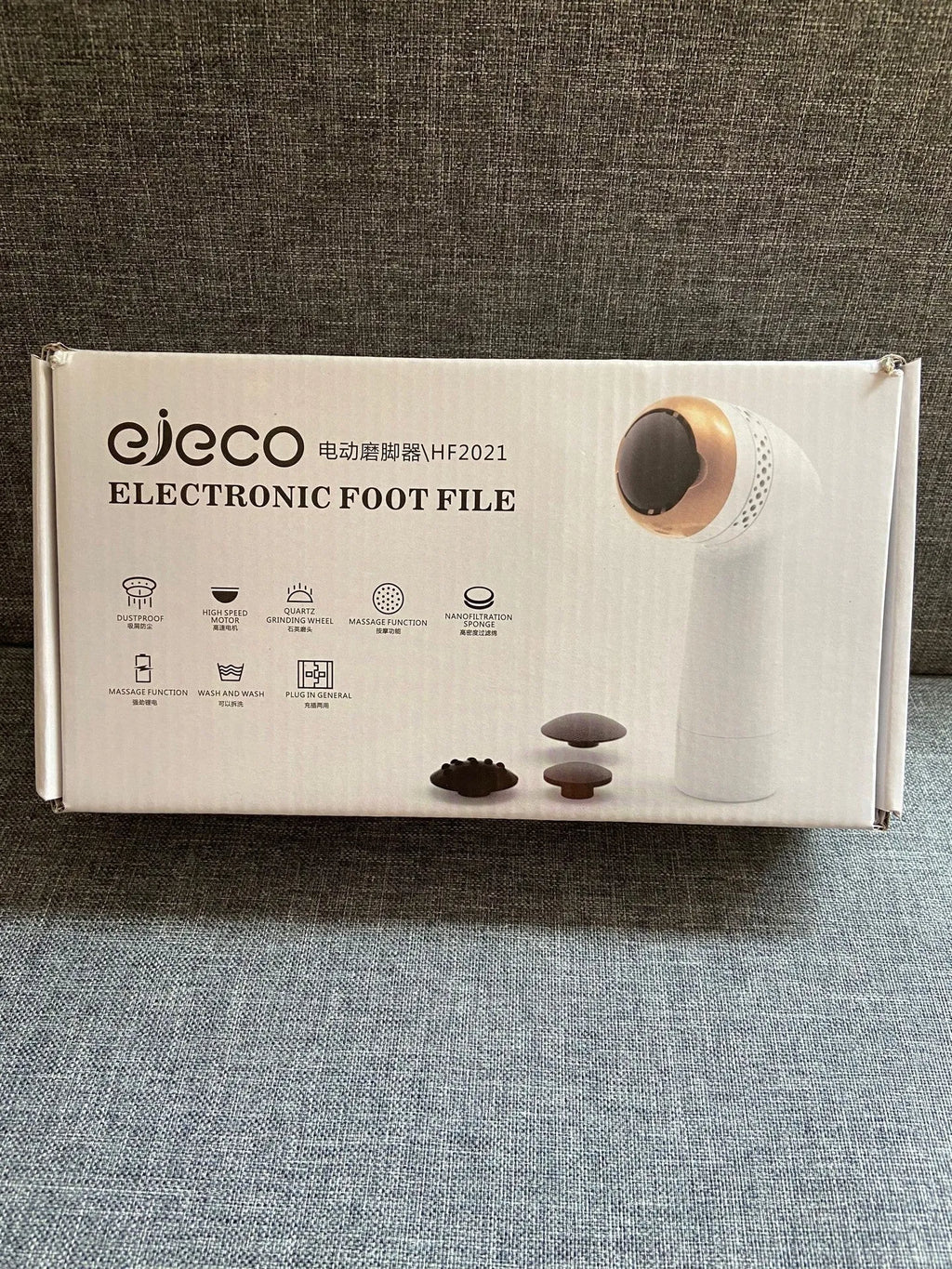 Electric vacuum foot grinder with quartz grinding head in a metallic finish, shown removing calluses on dry skin.