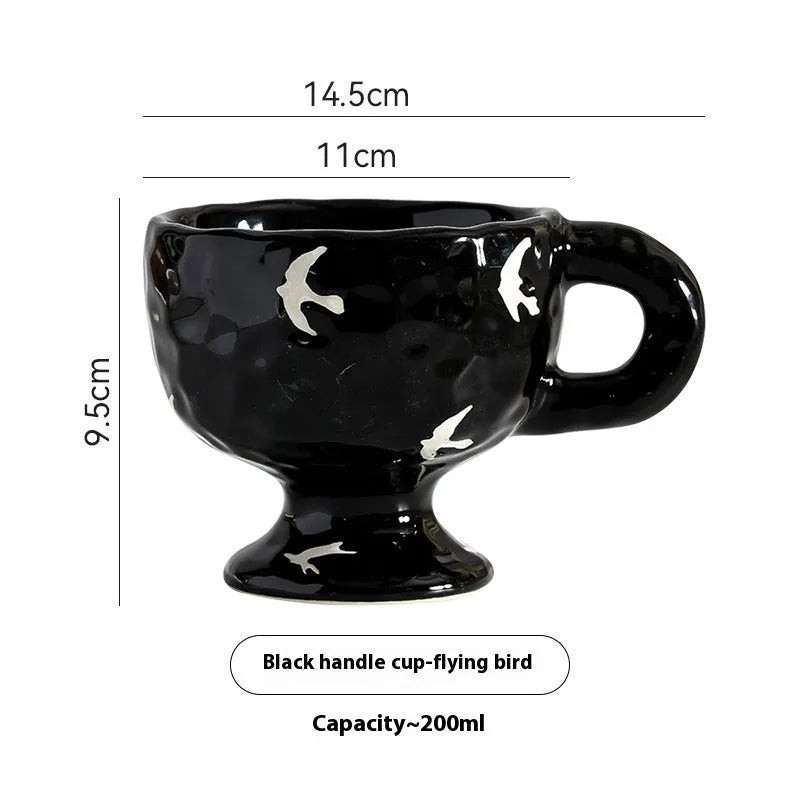 Hand-pinched irregular shaped solid colour ceramic mug on a table, showing its unique form and modern simplicity design.