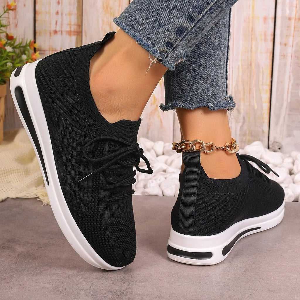 Women's low-top red casual sneakers with round toe and lace-up front on a white background.