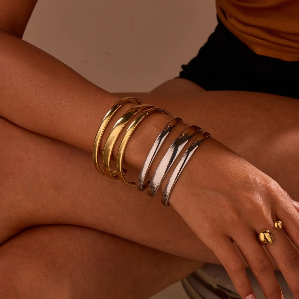 Geometric line stainless steel bracelet for women, showing gold electroplated and natural steel finish options