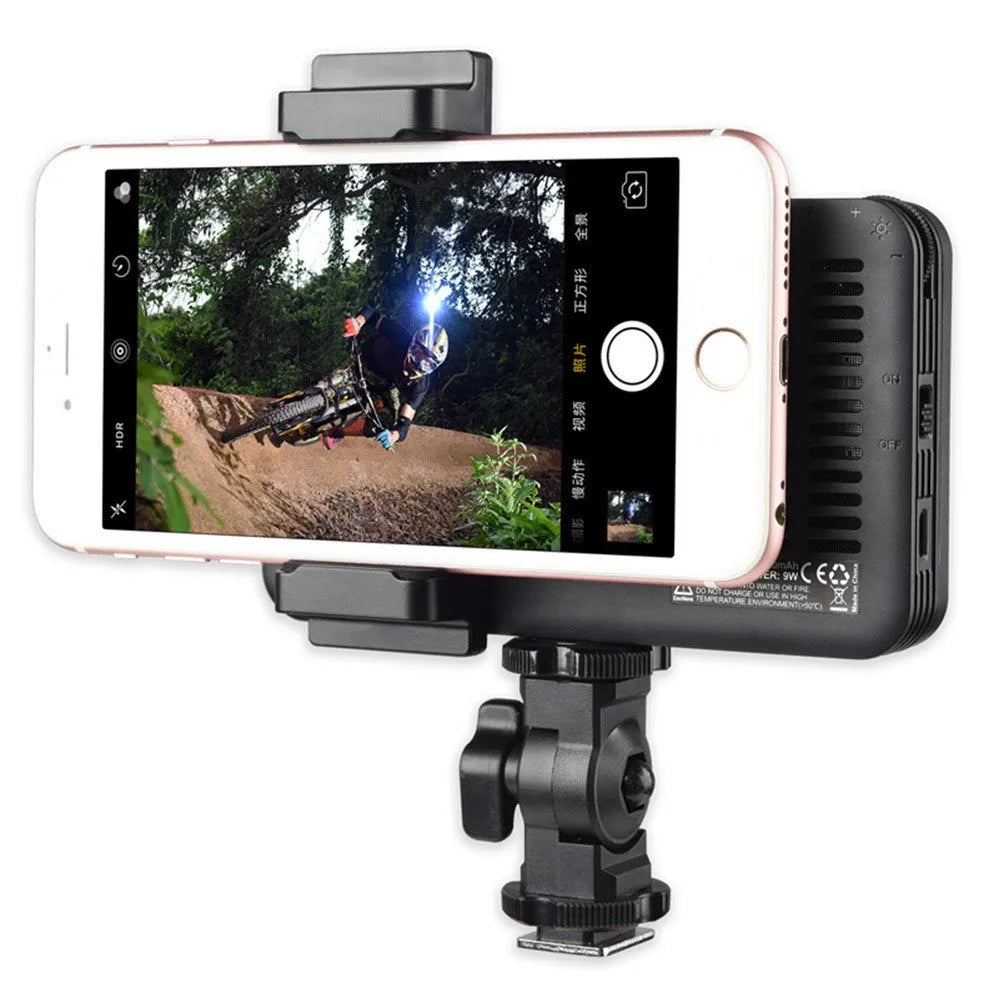 Shenniu M150 ultra-thin silver LED video light mounted on a mobile phone with bracket.