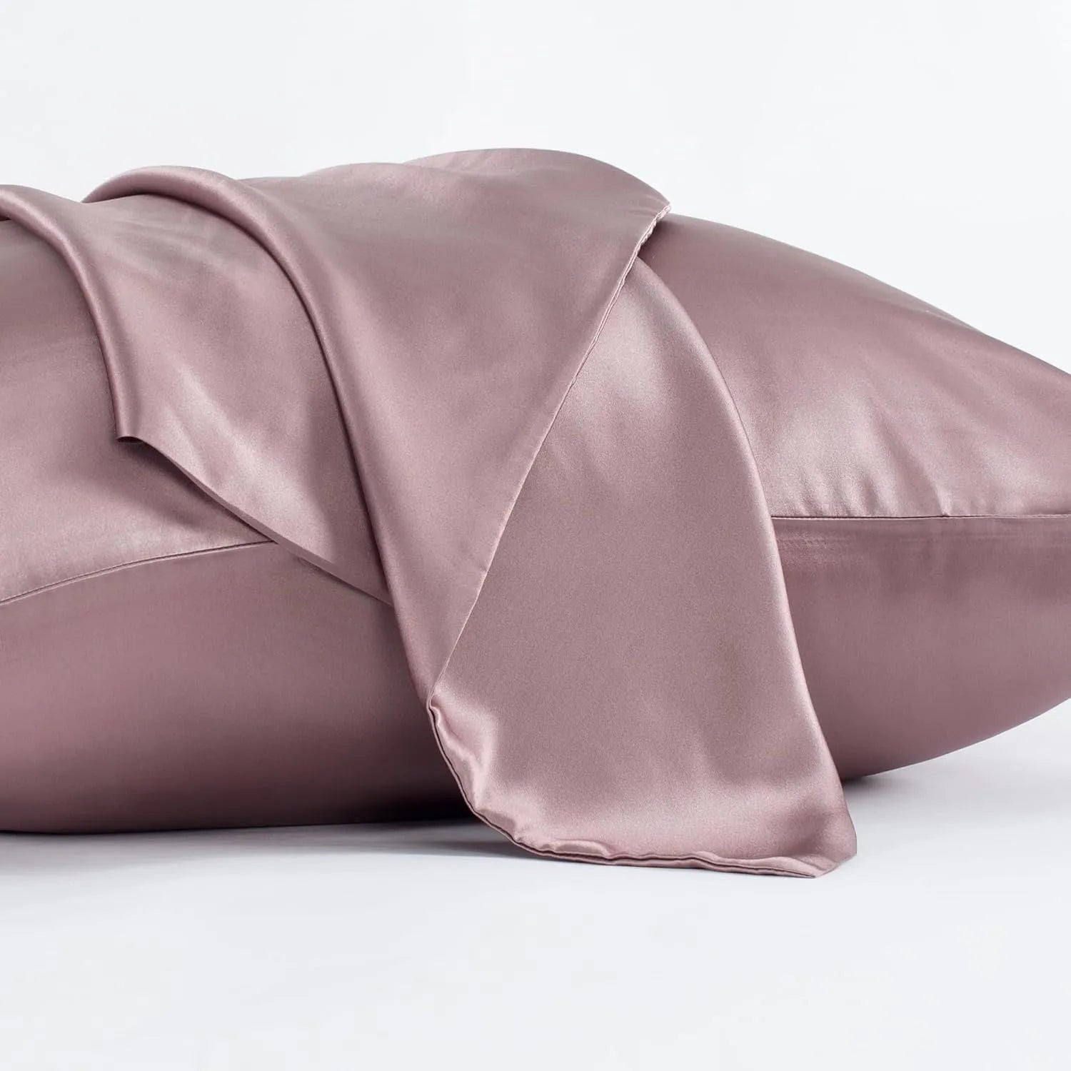 Dark grey 19 momme mulberry silk pillowcase showing envelope closure on a bed.