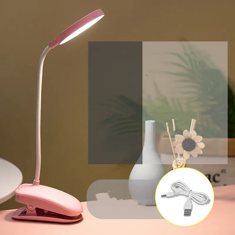 LED clip-on desk lamp with touch dimming, plastic shade, available in white, pink, or green.