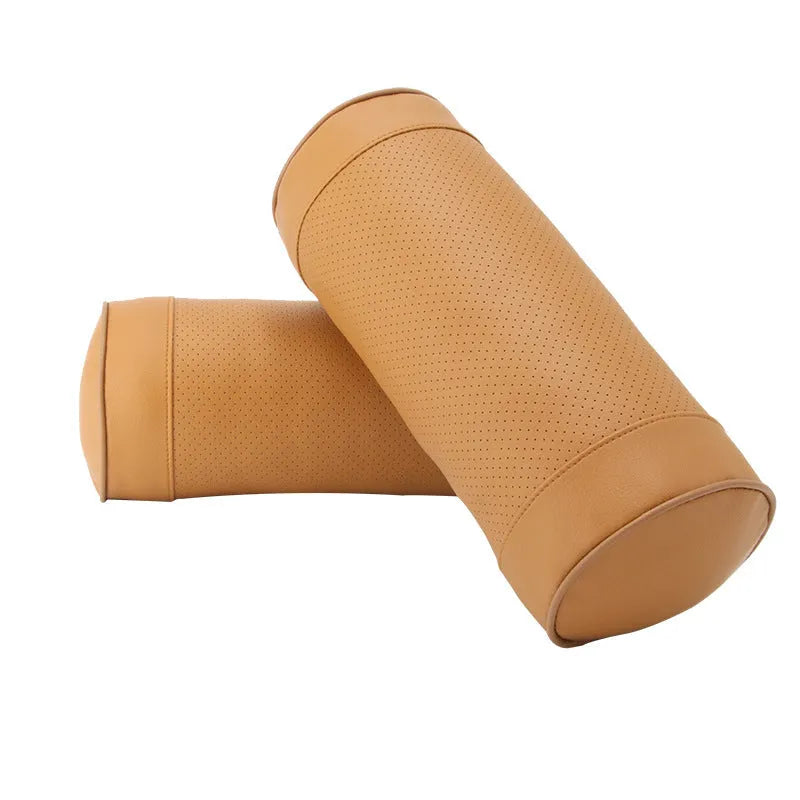 Leather cylindrical car seat pillow headrest with PP cotton filling and punching pattern, in beige, black, or brown.
