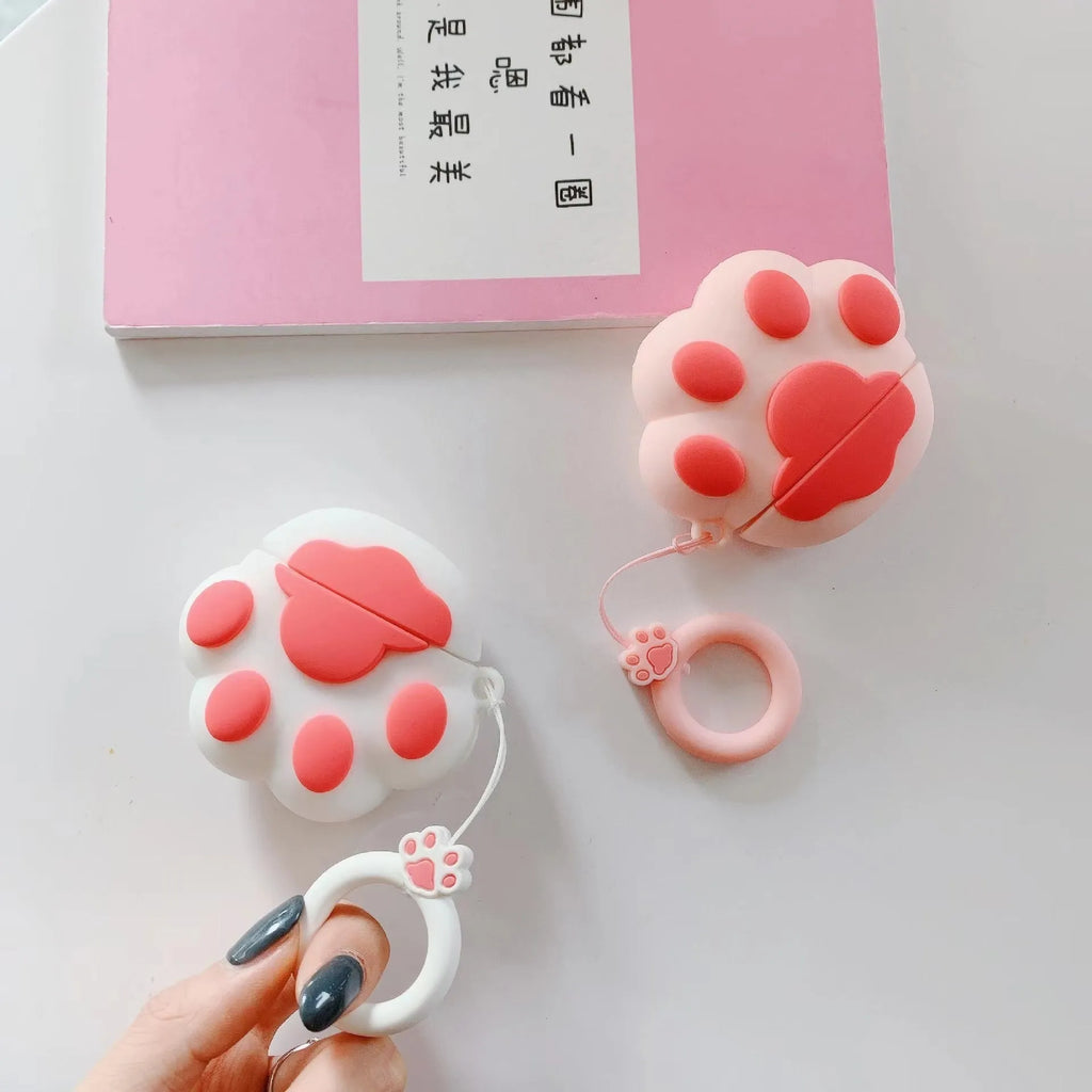 Cat's paw silicone earphone case for Apple AirPods, cute cartoon design, available in black, pink, or white.
