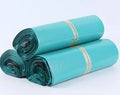 A bundle of 100 clear and coloured PE plastic courier bags with sticker seals for clothing protection.