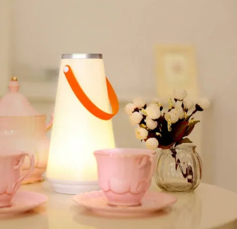 White rechargeable LED table lamp with adjustable brightness settings measuring 12x12x22cm