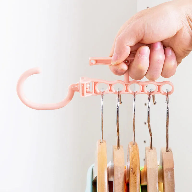 Blue rotating wardrobe hanger with five hooks and handle for clothing organisation