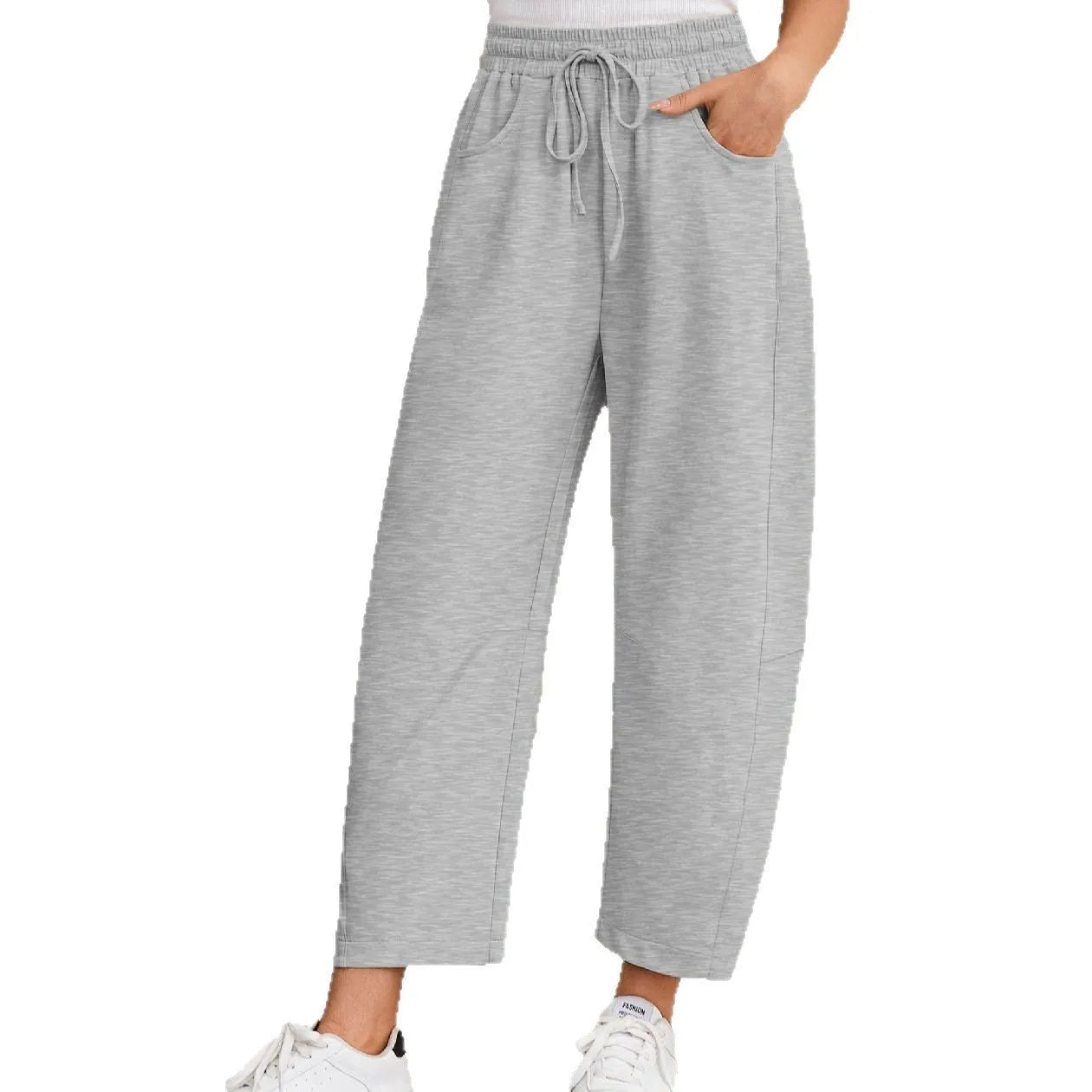 Loose cropped sweatpants with drawstring waist in apricot colour showing side pockets and street fashion styling