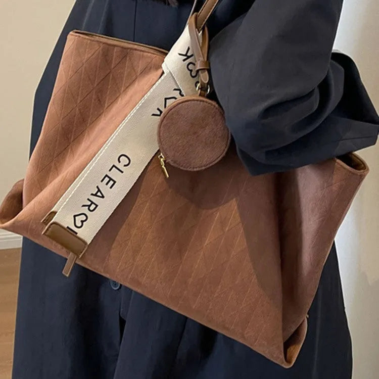 Large casual shoulder bag in horizontal square shape with sandwich pocket design and zip internal compartment