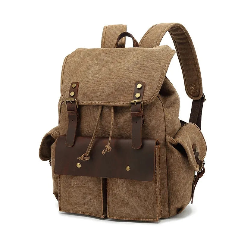 Retro-style canvas backpack in military green with antique bronze hardware, shown with a 16-inch laptop.