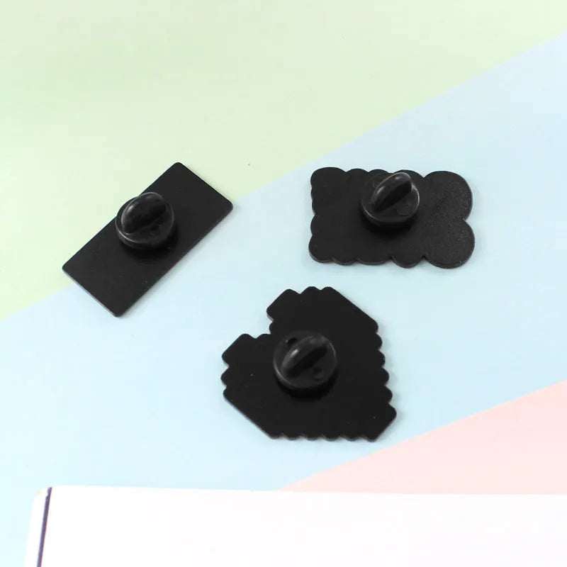 Stereo game console badge made from alloy metal in one of three colour options