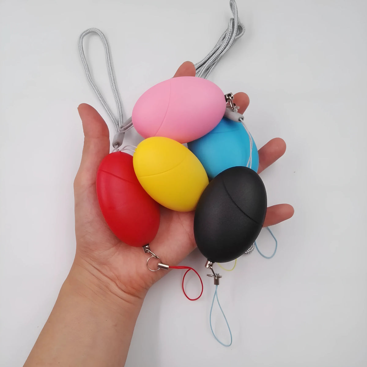 Oval personal alarm in black, blue, pink, red or yellow, 120dB wolf guard anti-tracking keyring alarm for women, elderly and children.