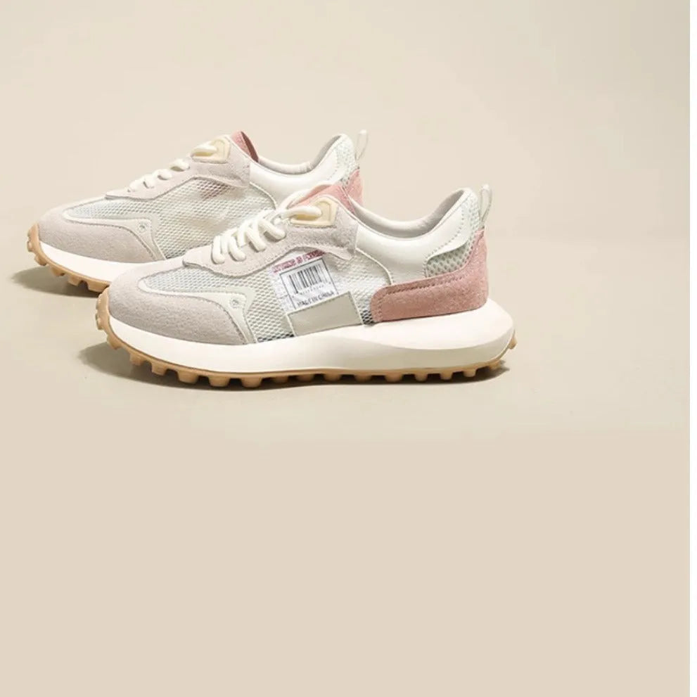 Women's gray retro sneaker with mesh lining and rubber sole on wooden floor