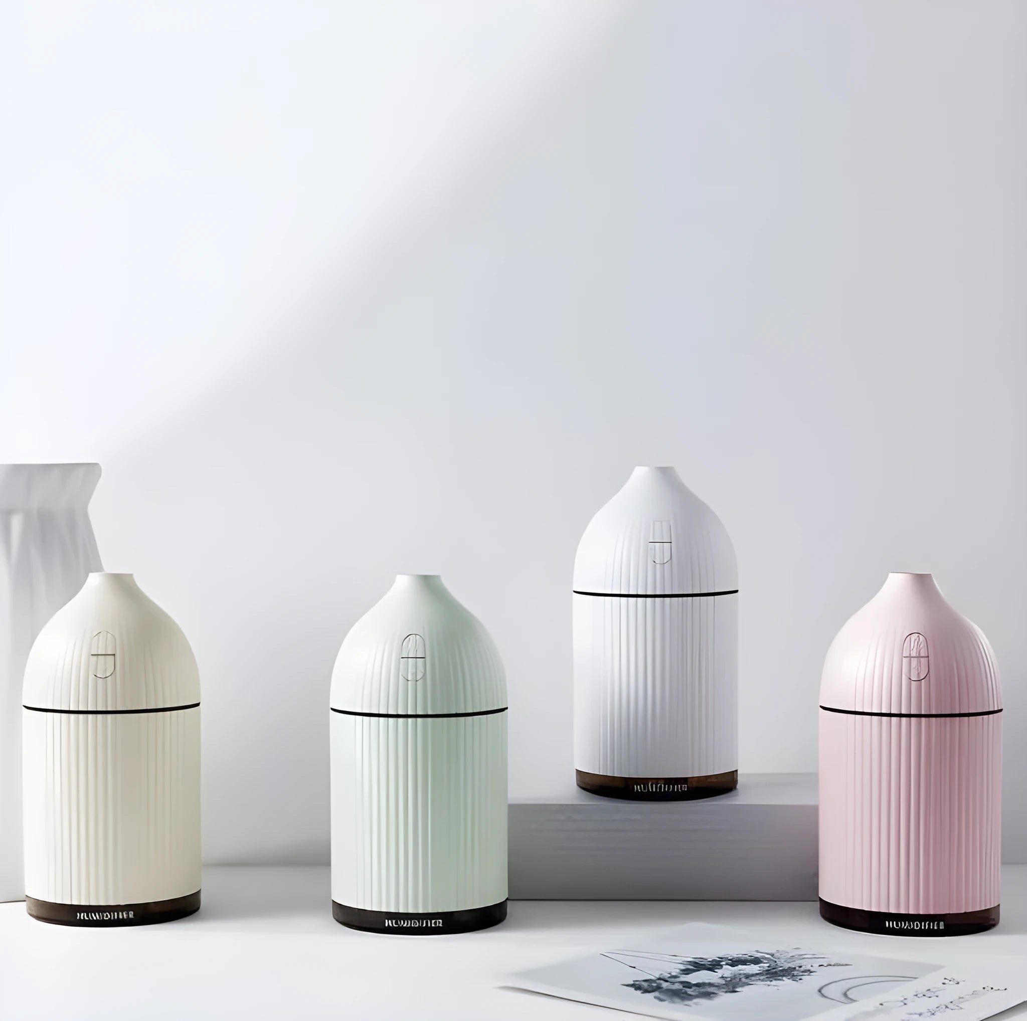 White ultrasonic aromatherapy diffuser and humidifier with LED light and 300ml capacity.