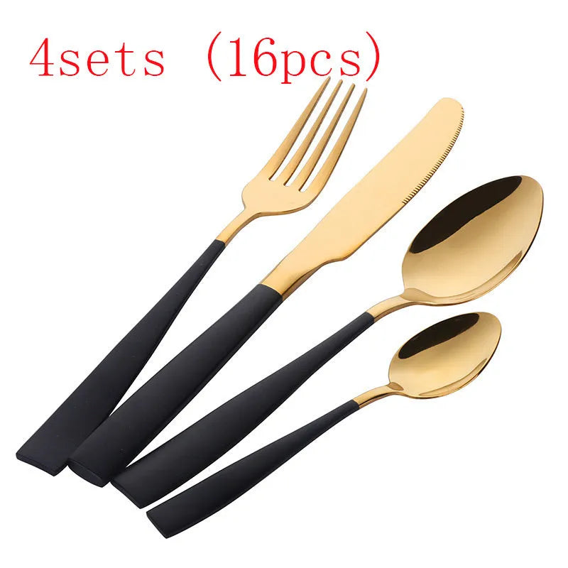 Black stainless steel four-piece cutlery set with mirror-polished finish on a plain surface