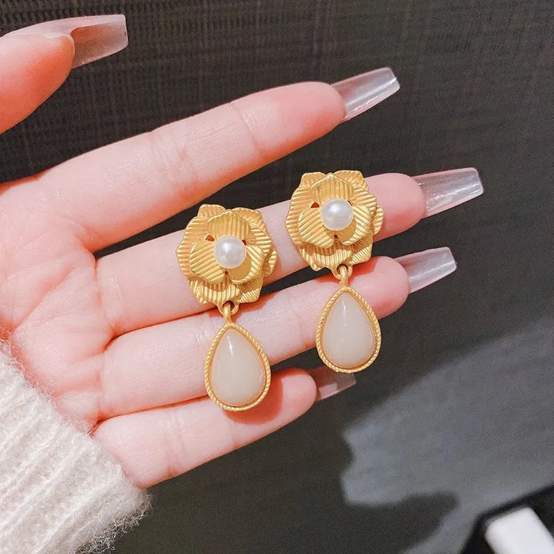 Gold-coloured floral stud earrings with a detailed needle rose pearl and opal stone design.