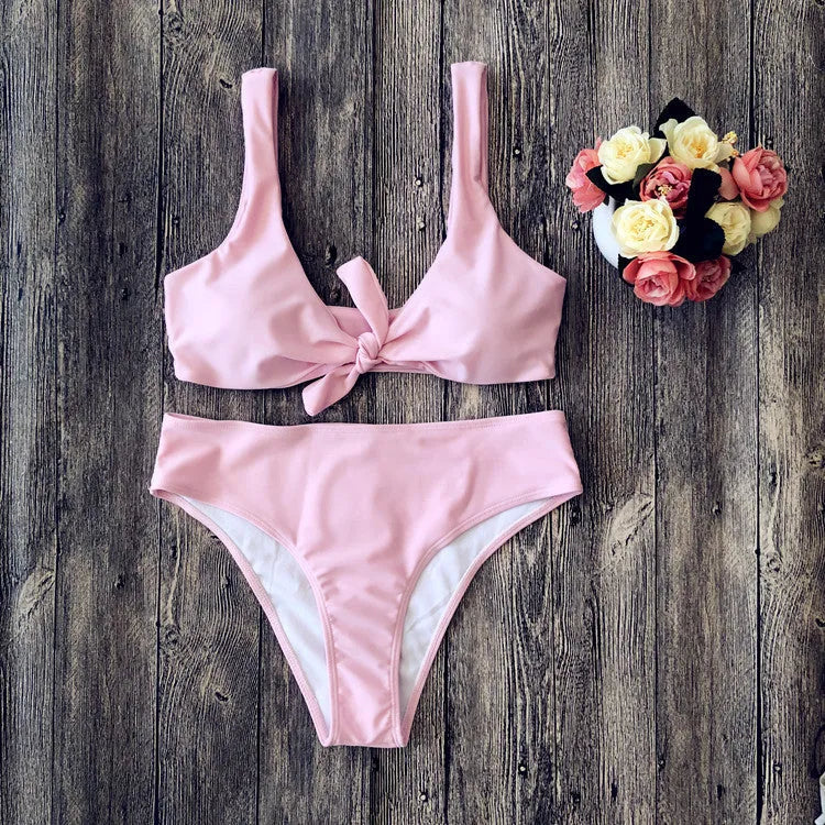 Women's solid colour bikini swimsuit set in polyester, showing sleeveless bra and matching briefs.