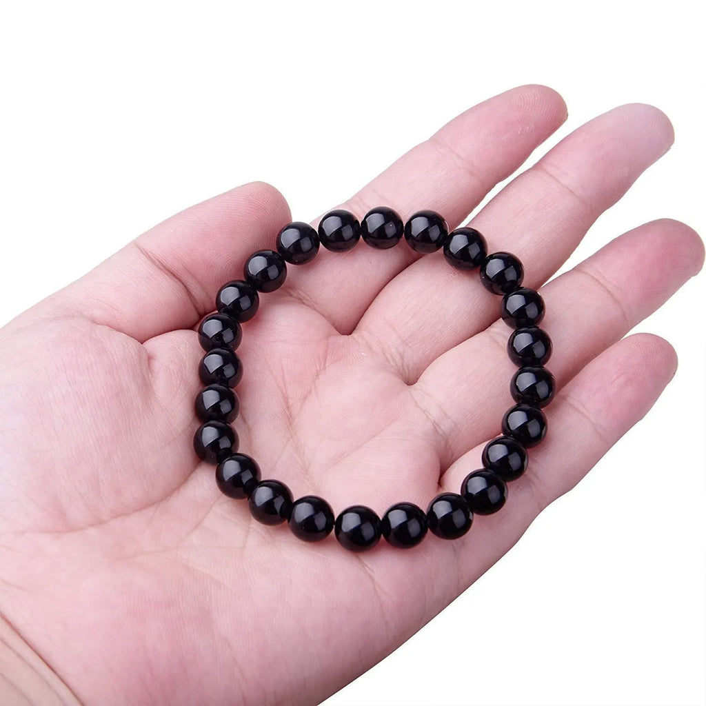 Black onyx bracelet with 8mm geometric agate beads on a black elastic cord.