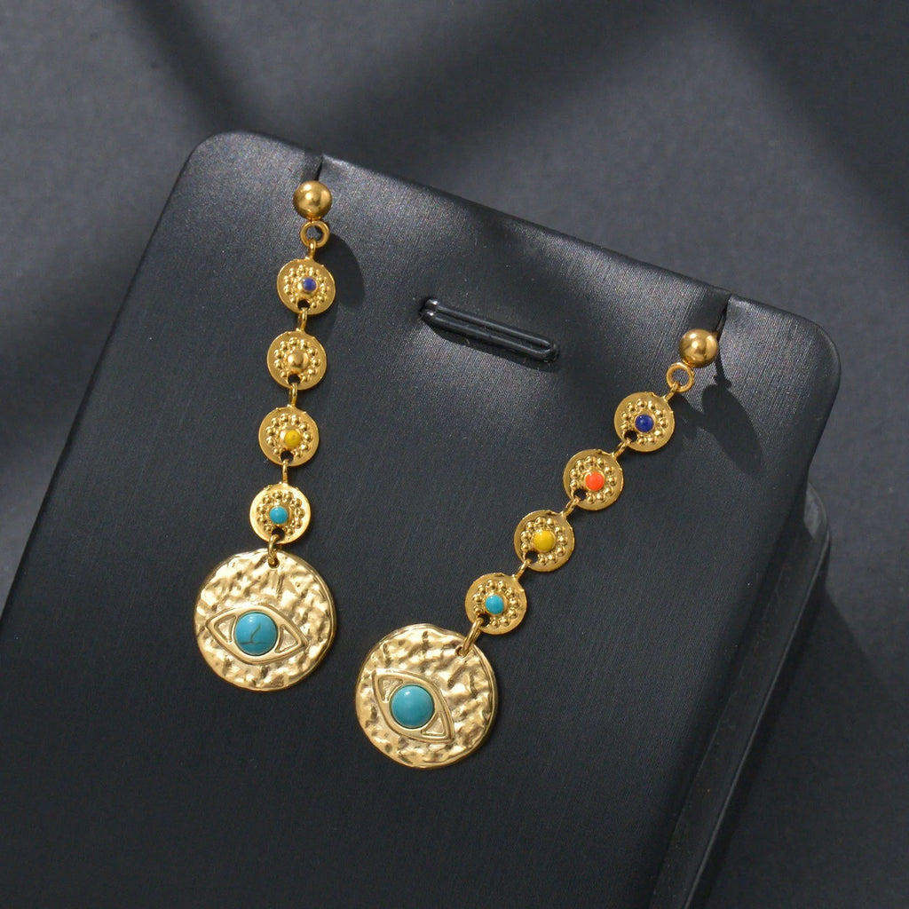 Stainless steel geometric drop earrings showing three designs: eight awn star, eye shape, and shell sun pattern