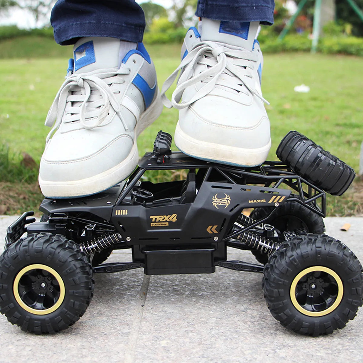 Large black 4WD remote control climbing car and a smaller silver high-speed RC car with wireless remotes